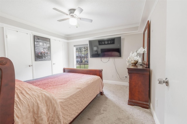 carpeted bedroom featuring ceiling fan and ornamental molding