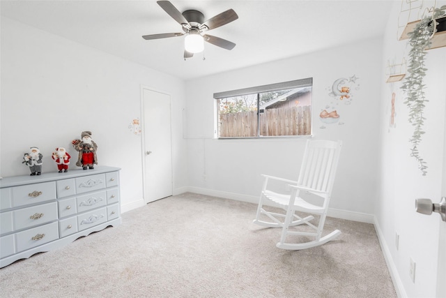 living area featuring ceiling fan and light colored carpet