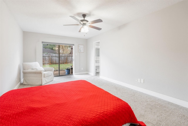 carpeted bedroom with ceiling fan, access to exterior, and a textured ceiling