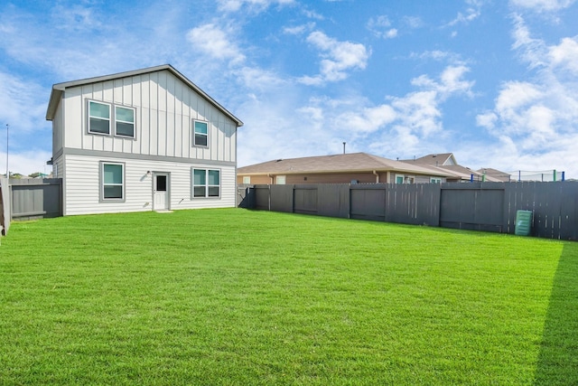 back of house with a yard