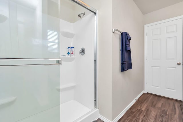 bathroom featuring hardwood / wood-style floors and an enclosed shower