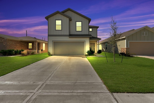 view of front of house featuring a lawn and a garage