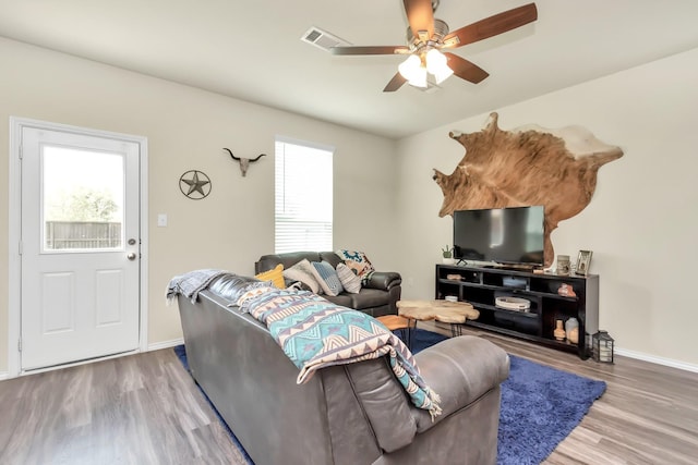 living room featuring ceiling fan and wood-type flooring