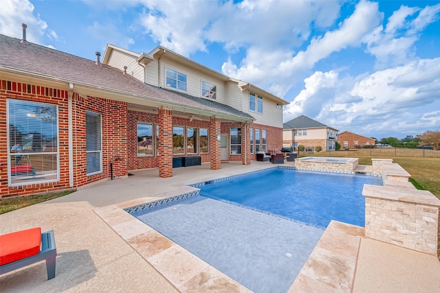 view of swimming pool with an in ground hot tub and a patio