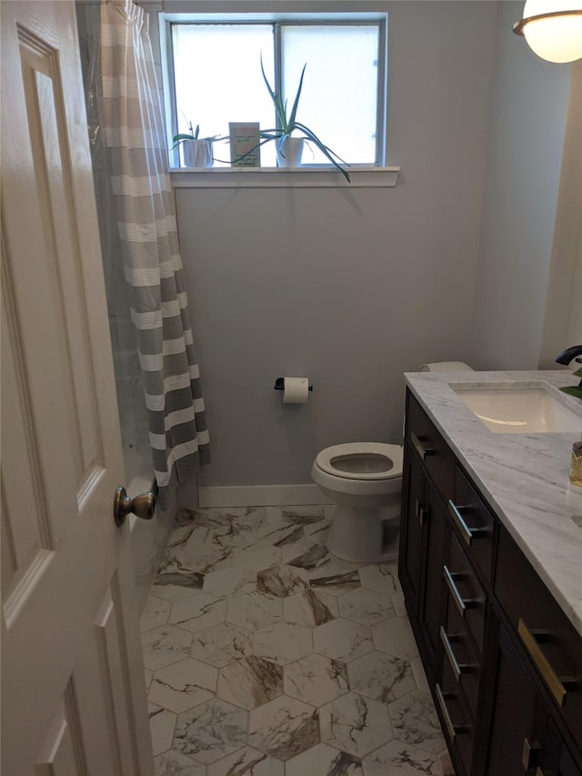 full bathroom with shower / bath combo, vanity, and toilet