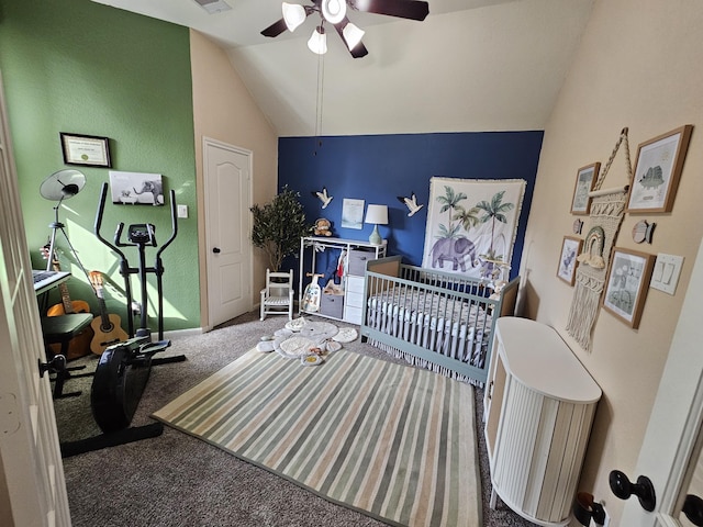 bedroom featuring a nursery area, ceiling fan, carpet floors, and vaulted ceiling