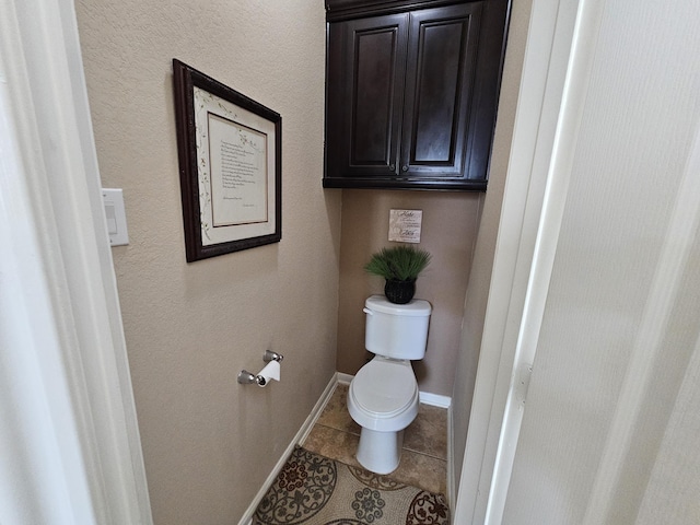 bathroom featuring tile patterned flooring and toilet