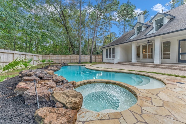 view of pool with ceiling fan and an in ground hot tub