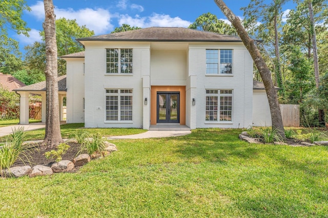 view of front of property with a front lawn and french doors