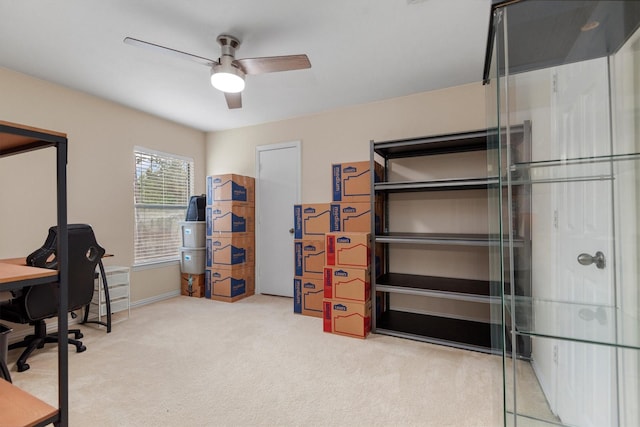 carpeted home office featuring ceiling fan