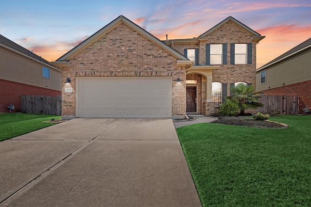 view of front of home featuring a yard and a garage