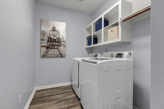 washroom with washing machine and dryer and dark hardwood / wood-style floors