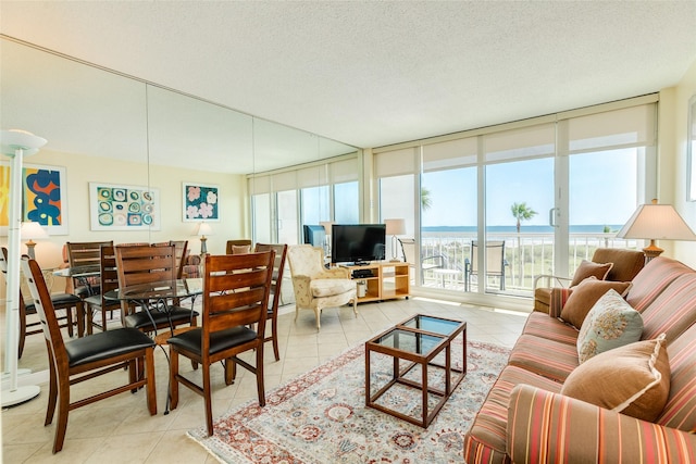 tiled living room with a wall of windows and a textured ceiling