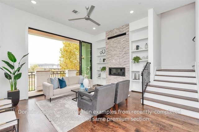 living room featuring a fireplace, ceiling fan, built in features, and dark wood-type flooring