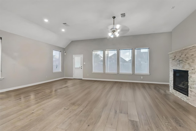 unfurnished living room with ceiling fan, light hardwood / wood-style flooring, a fireplace, and vaulted ceiling