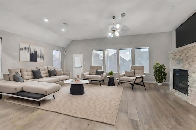 living room with ceiling fan, light hardwood / wood-style flooring, and lofted ceiling