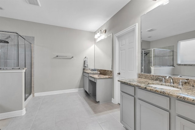 bathroom with tile patterned flooring, vanity, and a shower with shower door