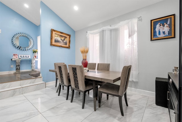 dining area with vaulted ceiling