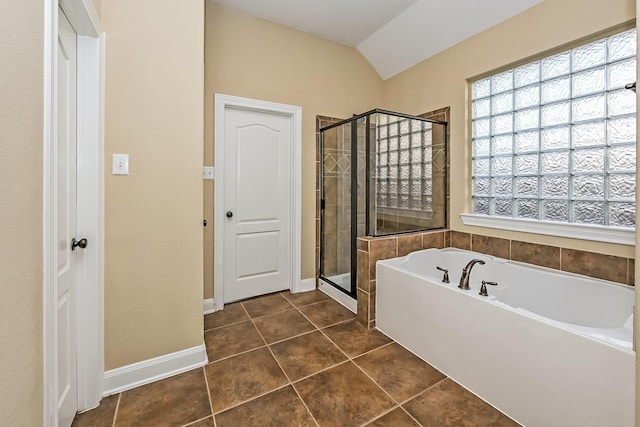 bathroom featuring plus walk in shower, tile patterned floors, and lofted ceiling