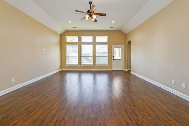 empty room with lofted ceiling, ceiling fan, and dark wood-type flooring