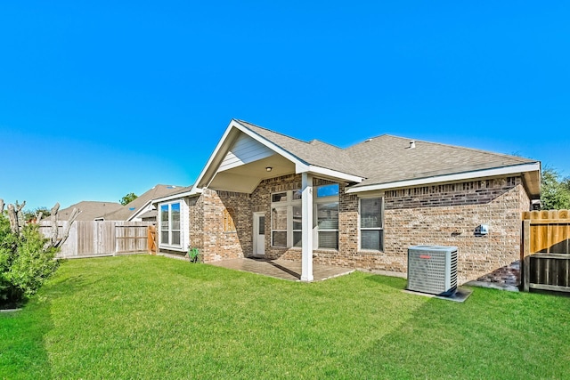 back of house featuring a lawn, a patio area, and cooling unit