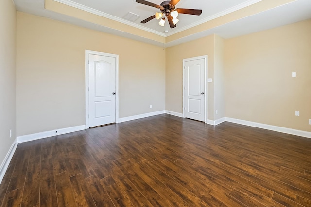 unfurnished room with dark hardwood / wood-style floors, a raised ceiling, ceiling fan, and ornamental molding