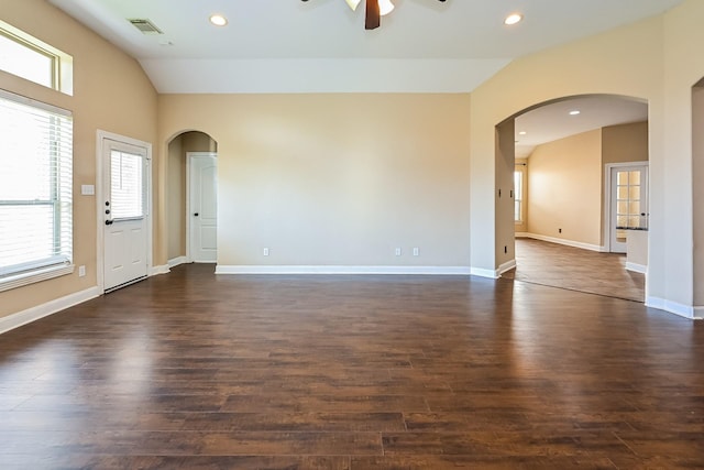 empty room featuring ceiling fan, dark wood-type flooring, and vaulted ceiling