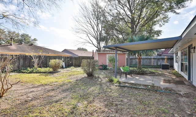 view of yard featuring a storage shed, a patio, and central AC