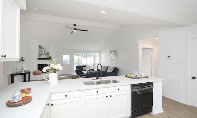 kitchen featuring white cabinets, vaulted ceiling with beams, sink, and black dishwasher