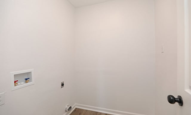 clothes washing area with washer hookup, electric dryer hookup, and hardwood / wood-style flooring