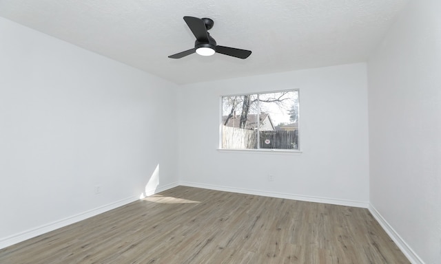 unfurnished room with ceiling fan and light hardwood / wood-style flooring