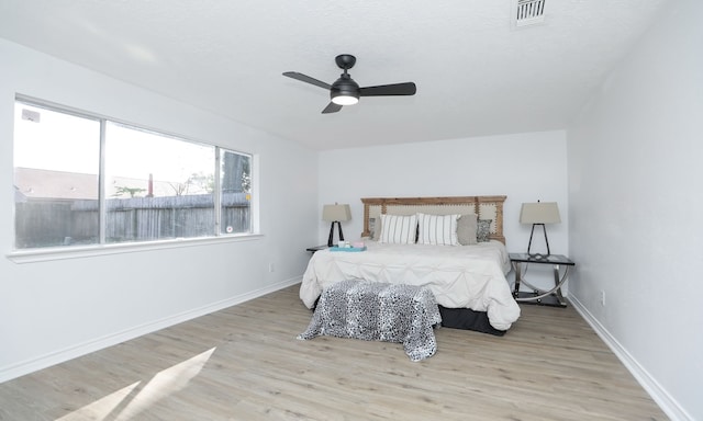 bedroom with ceiling fan and light hardwood / wood-style flooring