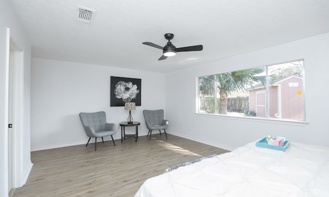 bedroom with light wood-type flooring and ceiling fan