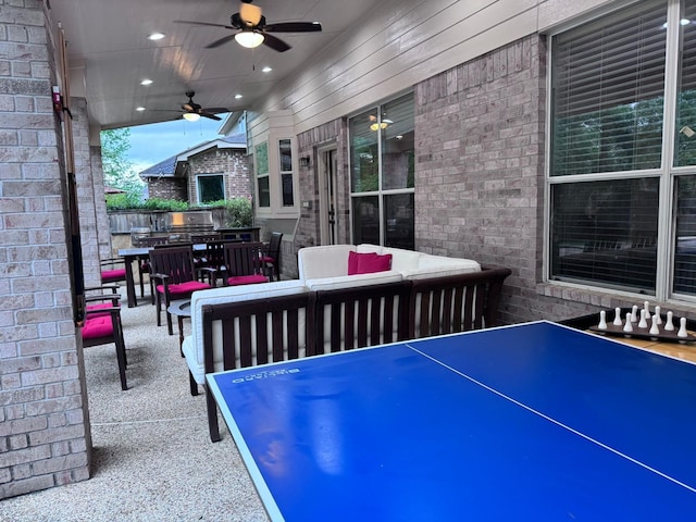 view of patio / terrace with an outdoor living space, ceiling fan, and grilling area