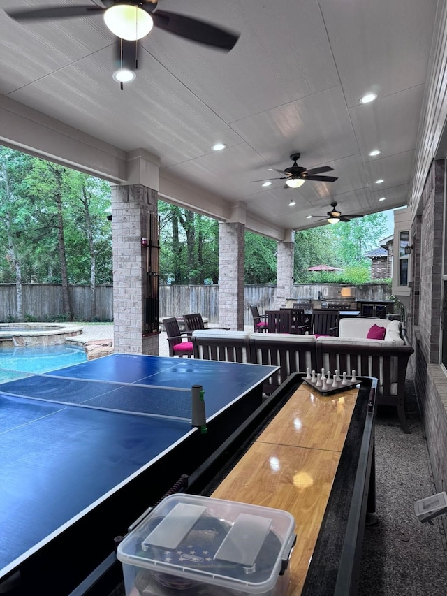 exterior space featuring a pool with hot tub