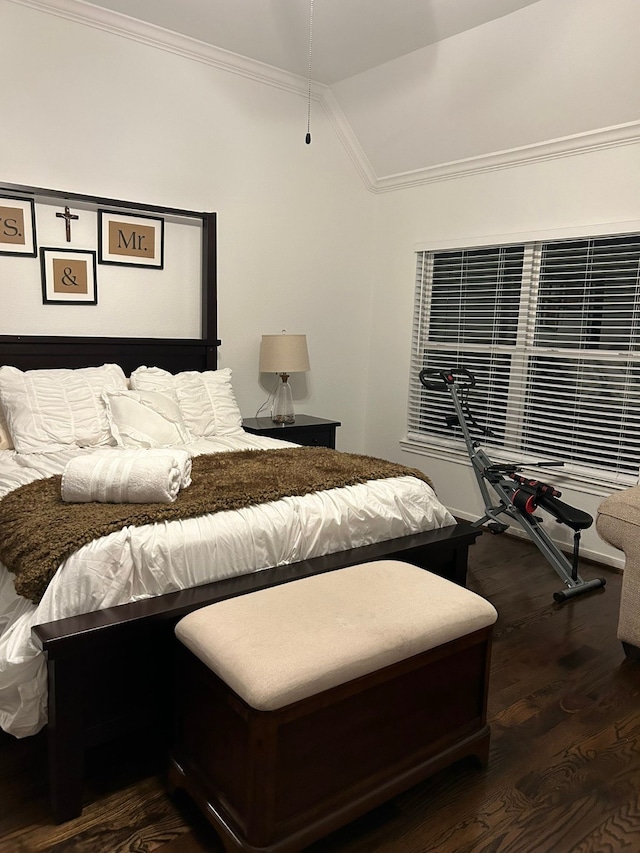 bedroom with crown molding, dark hardwood / wood-style floors, and lofted ceiling