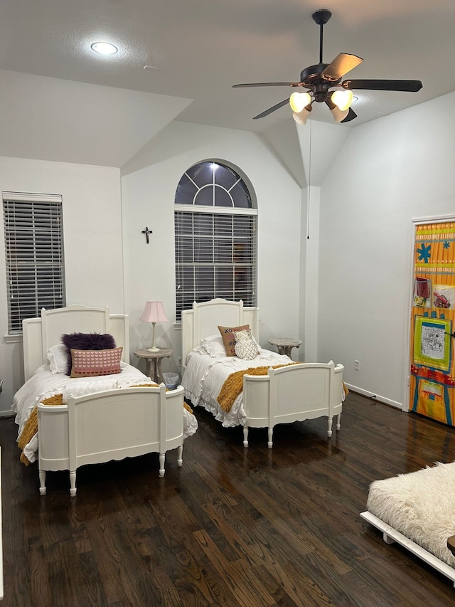 bedroom with ceiling fan, dark hardwood / wood-style flooring, and vaulted ceiling