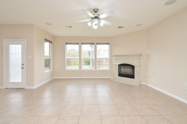 unfurnished living room featuring ceiling fan and light tile patterned flooring