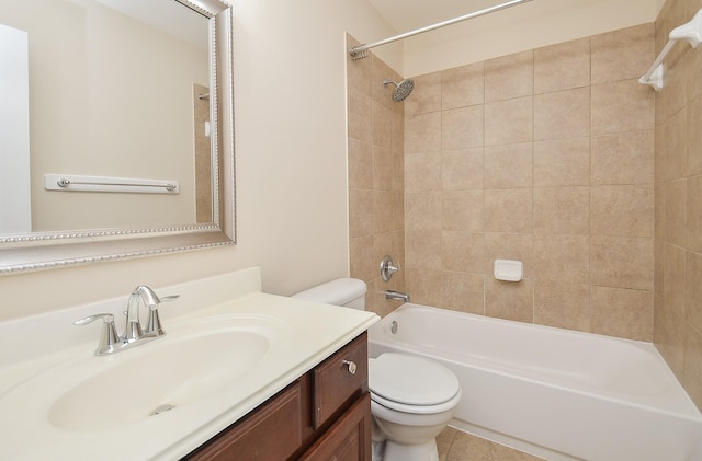 full bathroom featuring toilet, vanity, and tiled shower / bath