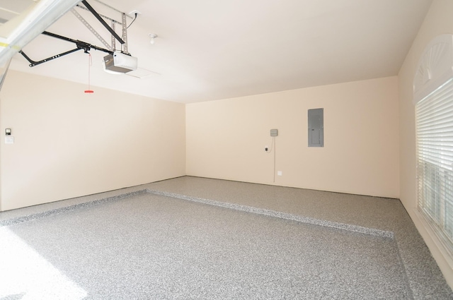 garage featuring electric panel and a garage door opener