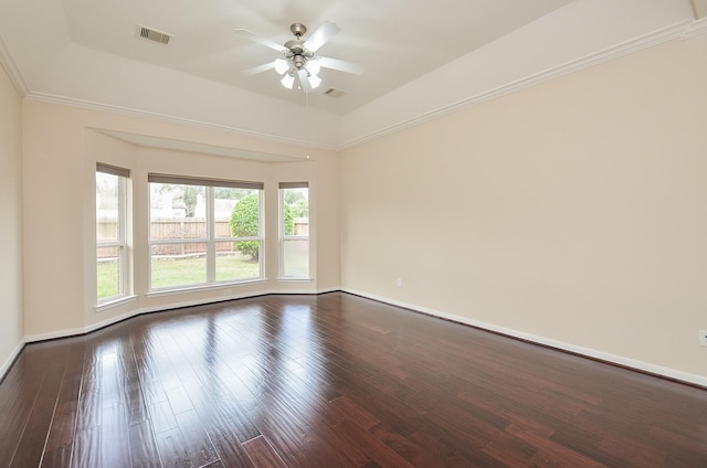 unfurnished room with a raised ceiling, ceiling fan, and hardwood / wood-style flooring