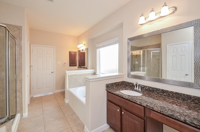 bathroom with plus walk in shower, vanity, and tile patterned flooring