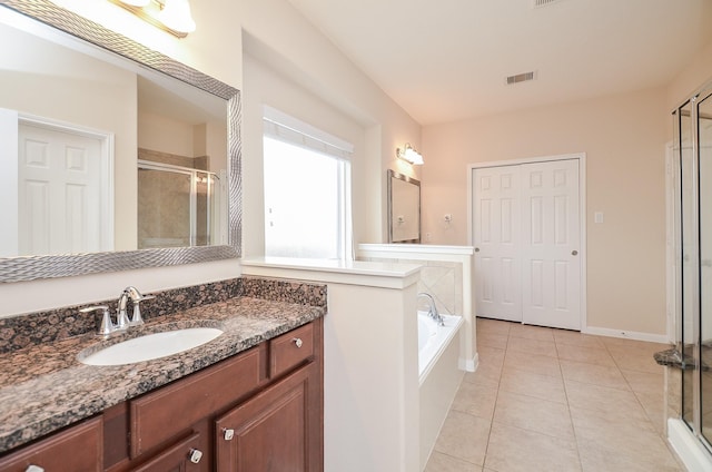 bathroom featuring vanity, tile patterned floors, and separate shower and tub