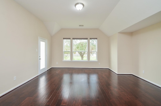 spare room with lofted ceiling and wood-type flooring