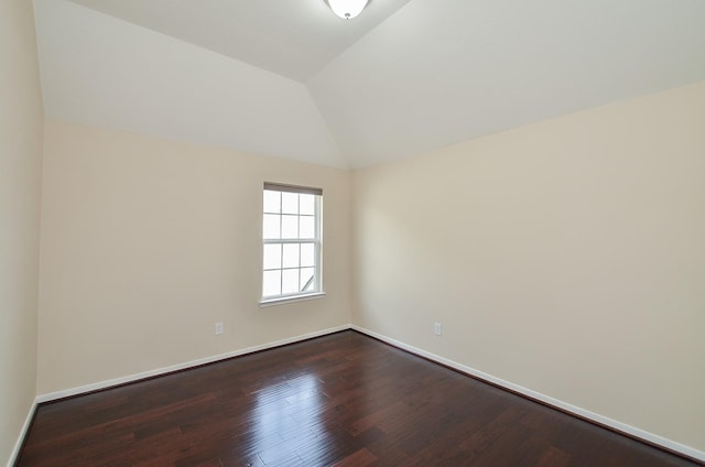 unfurnished room featuring hardwood / wood-style floors and lofted ceiling