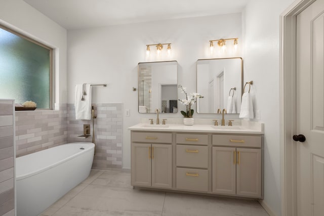 bathroom with vanity, a bath, and tile walls