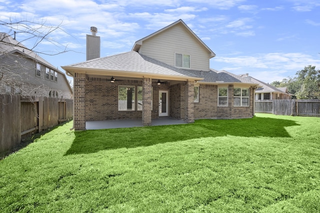 rear view of house with a lawn, ceiling fan, and a patio area