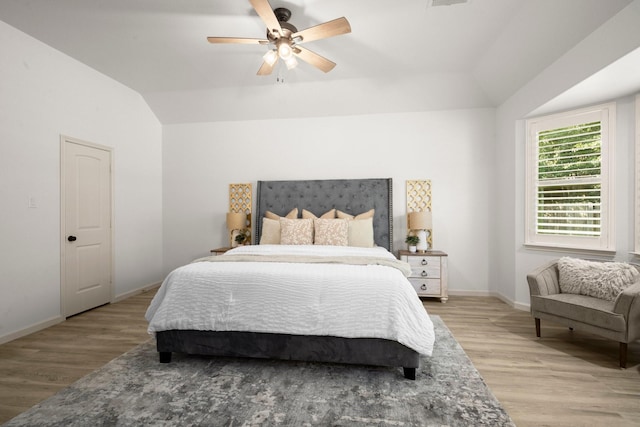 bedroom featuring vaulted ceiling, light hardwood / wood-style flooring, and ceiling fan