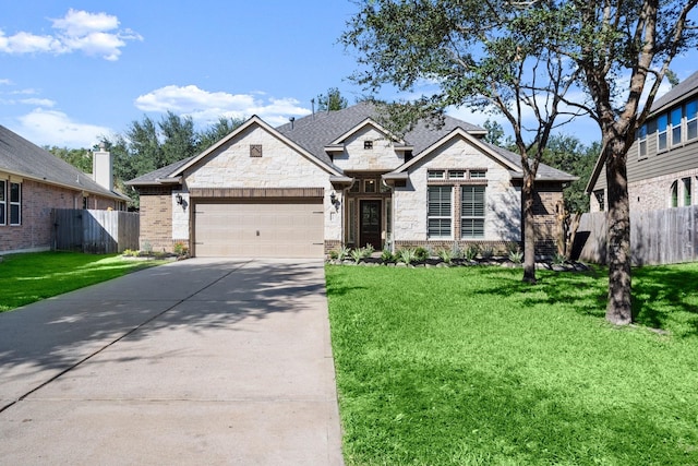 view of front of home with a garage and a front lawn