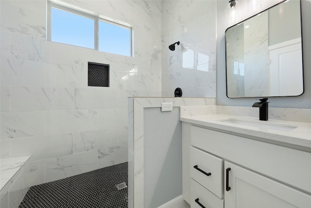 bathroom with vanity and tiled shower